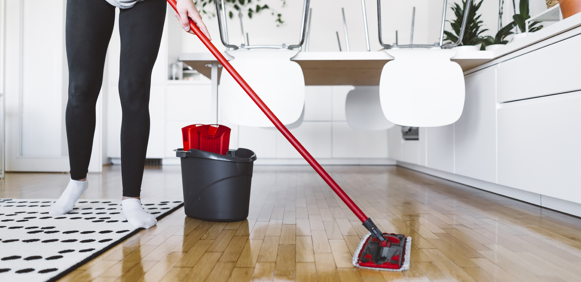 Person cleaning a hardwood floor